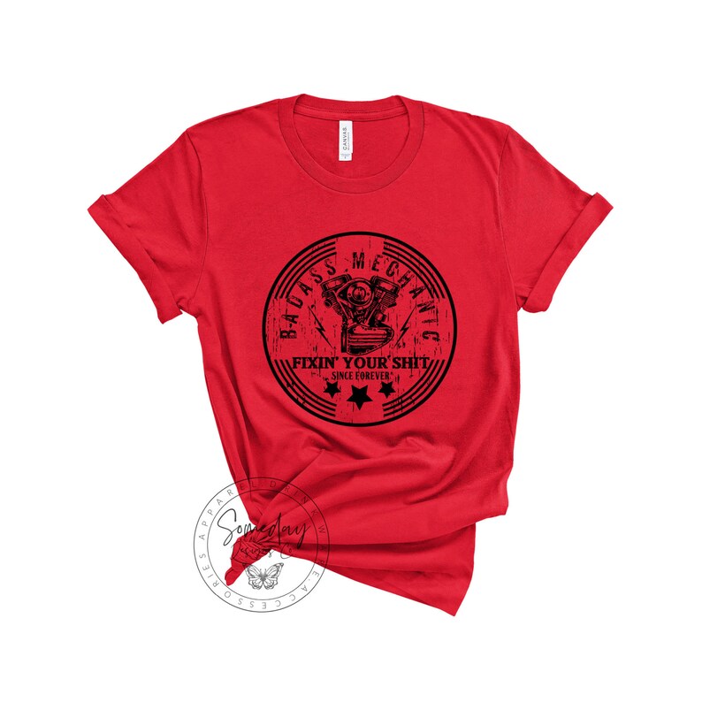 May include: Red t-shirt with a black and white graphic of a motorcycle engine with the text "Badass Mechanic Fixin' Your Shit Since Forever" in a circle.