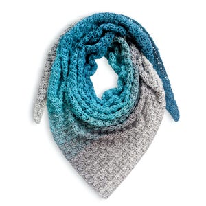 May include: A crocheted shawl in a triangular shape, featuring a gradient of colors from gray to teal and ending in a deep blue. The shawl is made of soft yarn, with a textured stitch pattern. The design is suitable for cool weather.