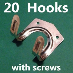 May include: A close-up of a silver metal hook with screws. The hook is attached to a silver metal plate. The text "20 Hooks with screws" is visible in the image.