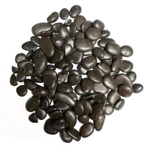 May include: A pile of smooth, dark grey river rocks. The rocks are various sizes and shapes, and they are all tumbled smooth.