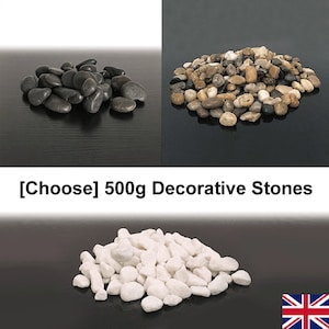 May include: Three piles of decorative stones, 500g each. The first pile is black, the second is a mix of brown, grey, and white, and the third is white.  [Choose] 500g Decorative Stones