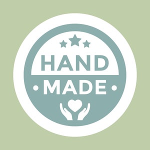 May include: A white circle with a blue circle inside. The blue circle has three white stars, the text "HAND MADE" in white, and a white heart in two white hands.