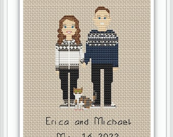 Peut inclure: Broderie au point de croix représentant un couple en pulls à motifs géométriques, se tenant la main, avec un chat à leurs pieds. Le texte "Erica and Michael" et "May 16, 2022" est en dessous. Encadré dans un cadre blanc.