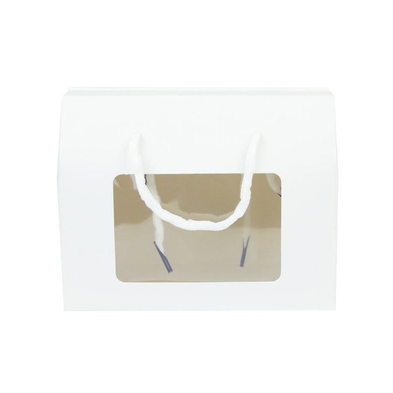 May include: White cardboard gift box with a clear window and white string handles. The box is designed for packaging and gifting small items.