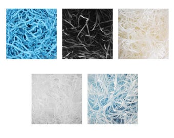 May include: An assortment of shredded paper in various colors. The image displays five square arrangements of paper in shades of blue, black, white, and a lighter blue. The paper is cut into thin strips, creating a textured, filler material.