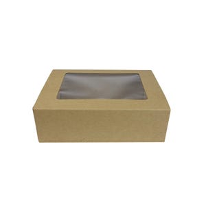 May include: A square, brown cardboard box with a clear plastic window on the top. The box is designed for packaging and displaying items. The box is made of corrugated cardboard.