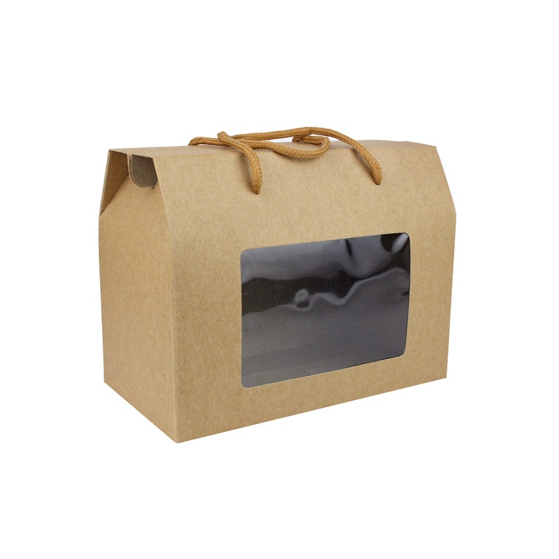 May include: A brown cardboard gift box with a clear window and a brown rope handle. The box is designed for packaging and gifting.