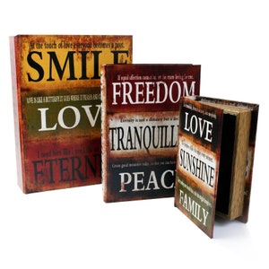 May include: Three decorative book-shaped boxes with a vintage look. Each box features a different inspirational quote and word, including "Smile", "Love", "Freedom", "Tranquility", "Peace", "Love", "Sunshine", and "Family".