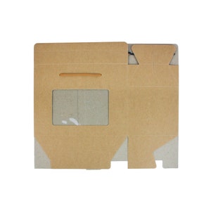 May include: A brown cardboard box with a window cut out. The box has a flap on the top and a small handle on the side.