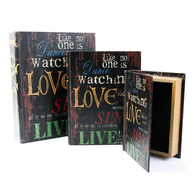 May include: Three decorative book-shaped boxes with a black background and colorful text. The text on the boxes reads "Like no one is watching, Dance, Love, Sin, Live".