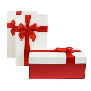 May include: Three white gift boxes with red ribbon bows. The box in the front is a larger box with a red lid and white base.