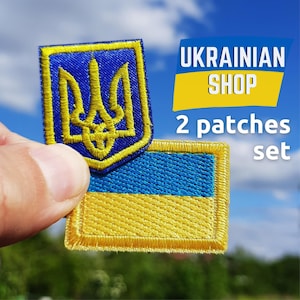May include: A set of two embroidered patches, one featuring the Ukrainian coat of arms and the other the Ukrainian flag. The patches are blue and yellow with gold edging. Text reads "UKRAINIAN SHOP" and "2 patches set".