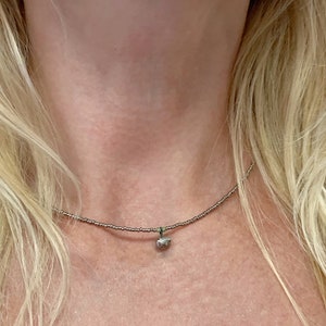 Minimalistic beaded necklace with a black porcelain, platinum plated pendant in little stone shape, elegant style gift for mother, sister