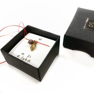 Black pearl and ceramic leaf minimal pendant on a string
