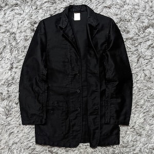 May include: A black jacket with a button-up front, two front pockets, and a notched collar. The jacket is made of a solid black fabric and has a classic, tailored design. The jacket is a medium length.