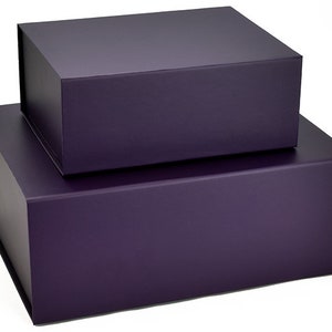 May include: Two purple gift boxes stacked on top of each other. The top box is slightly smaller than the bottom box.