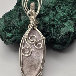 May include: A handmade, wooden cutting board with a natural finish. The board features a live edge on one side and a rectangular shape. It is approximately 18 inches long and 12 inches wide.