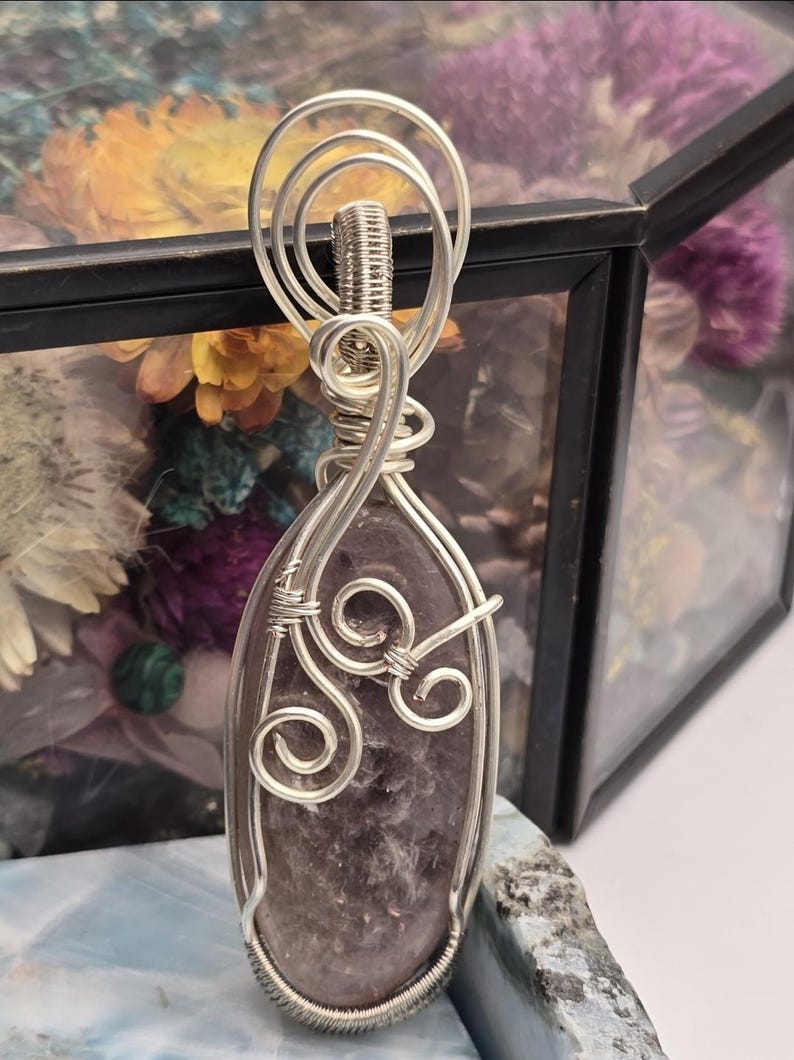 May include: A white ceramic mug with a black handle and the text "But First, Coffee" in a bold, black font. The mug is set against a neutral background, highlighting its simple design.