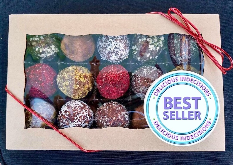 May include: A box of assorted chocolate truffles with a red ribbon and a sticker that says "Delicious Indecisions Best Seller Delicious Indecisions".