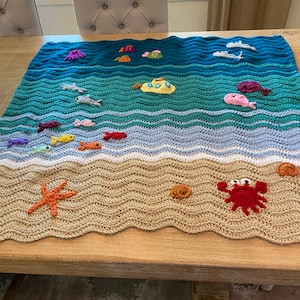 Manta de bebé con forma de criatura marina