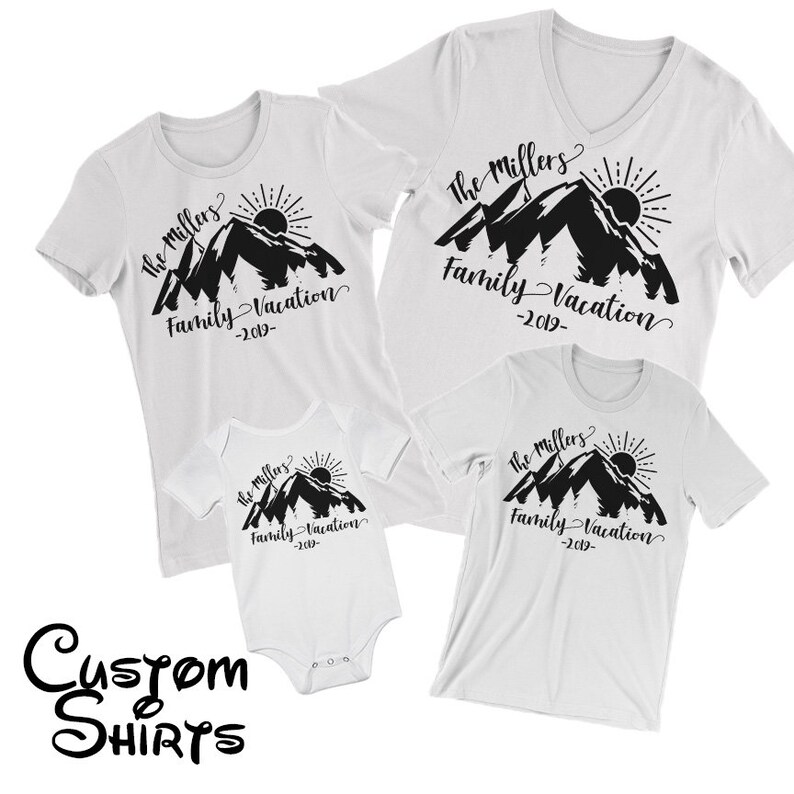 May include: A set of three white t-shirts with a black mountain range design and the text "The Millers Family Vacation -2019-." The shirts are in different sizes, with one being a baby onesie.