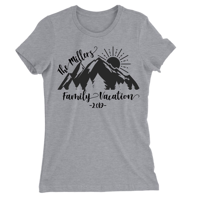 May include: Gray t-shirt with a black mountain silhouette, sun, and trees. The text "The Millers Family Vacation -2019- " is printed on the shirt.