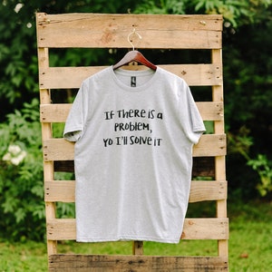 May include: A grey t-shirt with the text "If there is a problem, yo I'll solve it" printed in black.