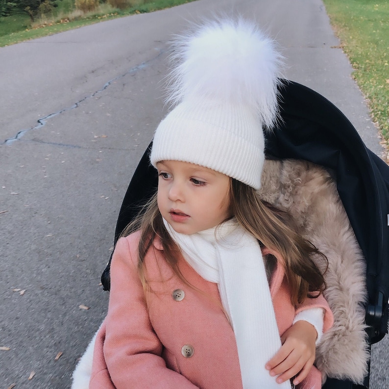 White hat with fur pom