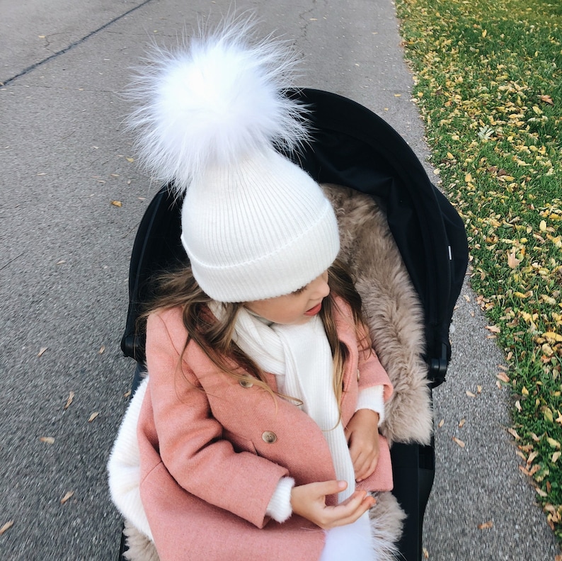 White hat with fur pom