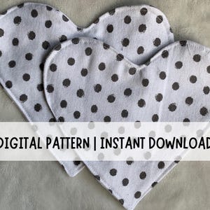 May include: Two heart-shaped fabric pieces with a white background and dark gray polka dots. The text "DIGITAL PATTERN | INSTANT DOWNLOAD" is displayed across the bottom of the image.