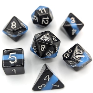 May include: A set of seven black and blue dice with silver numbers. The dice are a d4, d6, d8, d10, d%, d12, and d20.