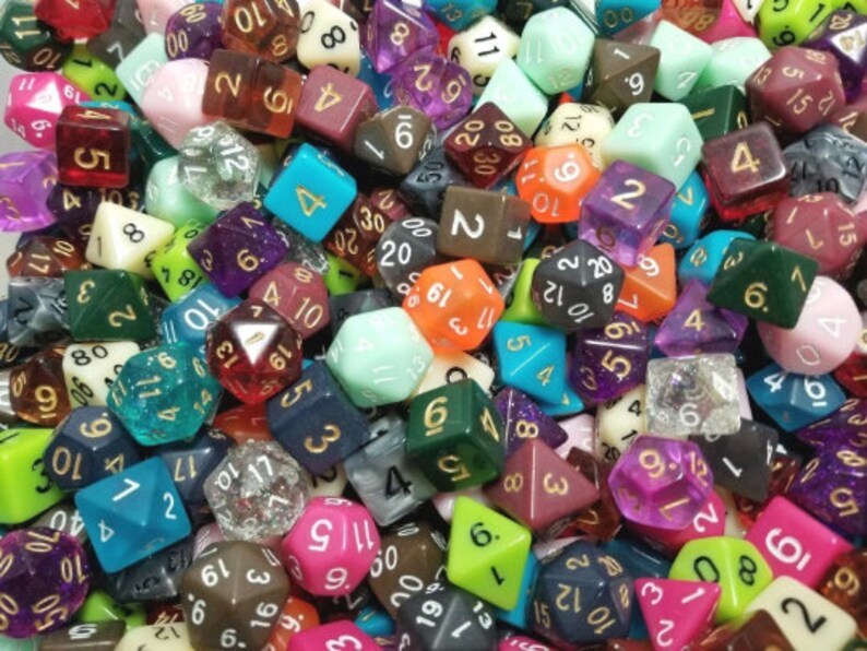 May include: A vibrant assortment of polyhedral dice in various colors, including green, purple, orange, and blue. The dice are scattered, showcasing different shapes and numbers, ideal for tabletop gaming. The image is a close-up, highlighting the details of each die.