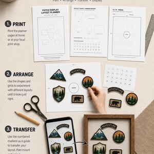 May include: A patch display layout planner kit featuring printed instructional sheets, numbered markers, scissors, a pencil, a smartphone displaying a patch arrangement, and a wooden frame containing embroidered nature-themed patches.