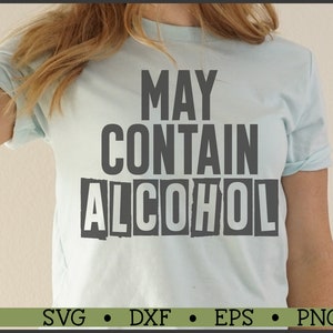 May include: A light blue t-shirt with the text "MAY CONTAIN ALCOHOL" printed in black and white. The text is in a distressed font style.