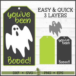 May include: A printable Halloween tag with a ghost and the text "you've been booed!" in green and black. The tag is designed to be cut out and layered for a 3D effect.