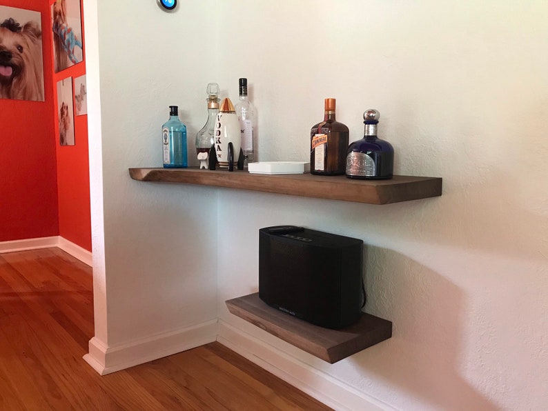 These HEAVY DUTY live edge floating shelves (floating bracket included) are handmade from SOLID 2" thick walnut. Use these floating shelves for storage, kitchen shelves or as a bookshelf. The possibilities are endless.