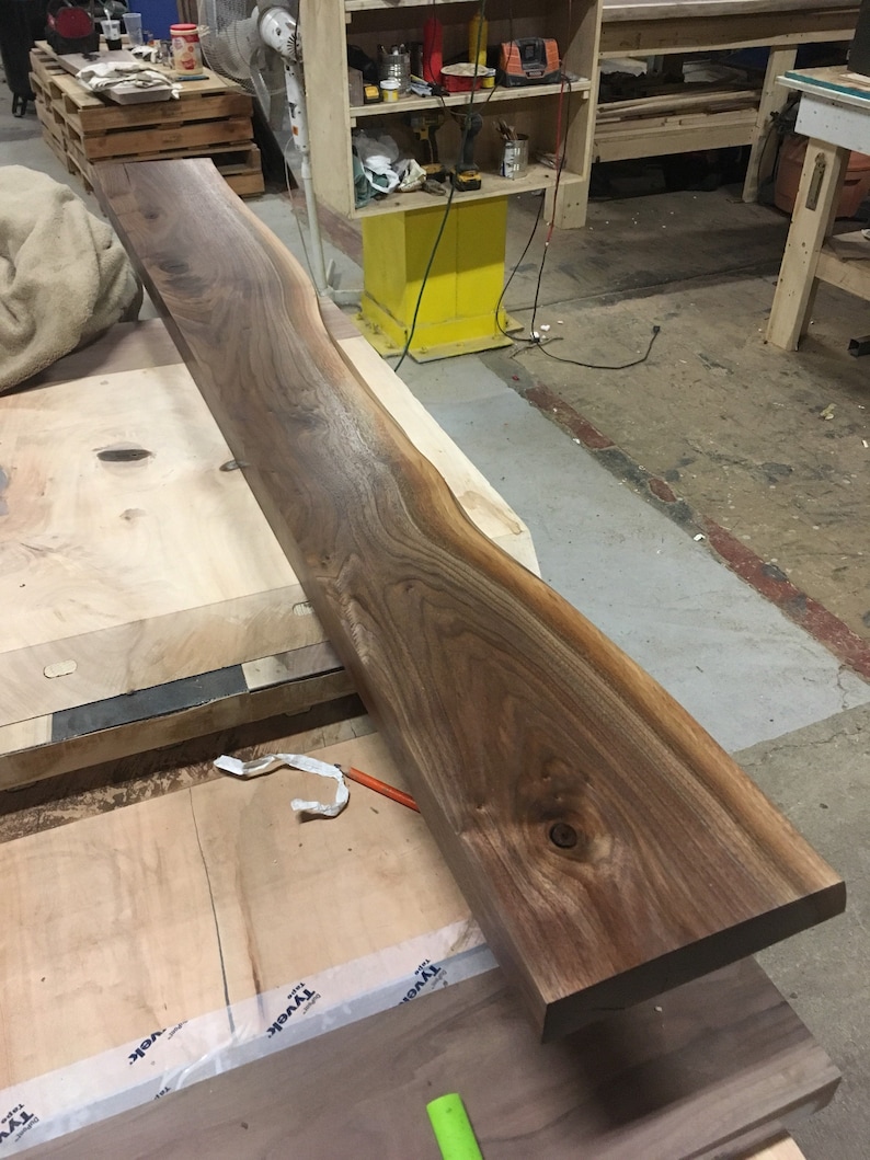 These HEAVY DUTY live edge floating shelves (floating bracket included) are handmade from SOLID 2" thick walnut. Use these floating shelves for storage, kitchen shelves or as a bookshelf. The possibilities are endless.