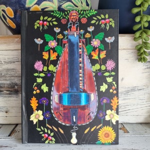 Hurdy-gurdy floral design hard backed note book. Ruled feint. 64 paqes