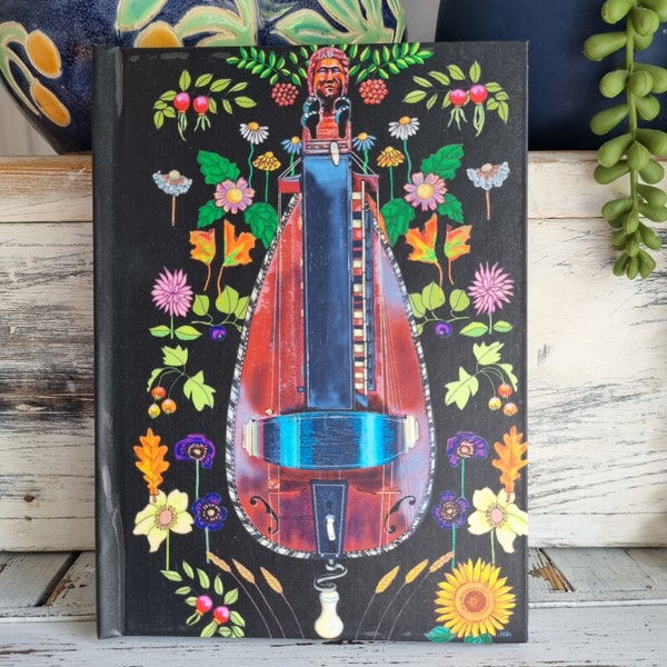 Hurdy-gurdy floral design hard backed note book. Ruled feint. 64 paqes