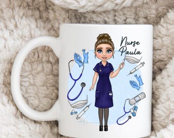 May include: White ceramic mug featuring a cartoon illustration of a nurse in a blue uniform, surrounded by medical tools. The mug has the text "Nurse Paula" in a handwritten style. The design includes a stethoscope, syringe, and bandages.