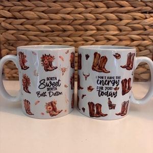Peut inclure: Deux tasses en céramique blanche avec un motif de bottes de cowboy et de fleurs. Une tasse porte l'inscription "Sorta Sweet Sorta Beth Dutton" et l'autre tasse porte l'inscription "I don't have the energy for you today".