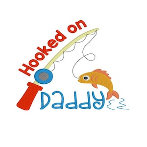 May include: A red and blue fishing rod with a fish on the line. The text "Hooked on Daddy" is written below the rod.