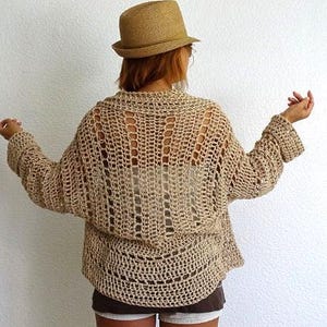 📝 Description:
Boho Crochet Mesh Cardigan – Handmade Lightweight Open Stitch Sweater

Embrace effortless summer style with this hand-crocheted openwork cardigan. Crafted with breathable natural Eco cotton yarn in a neutral sand beige tone, this airy, oversized sweater is perfect as a stylish beach cover-up or a relaxed boho layering piece.