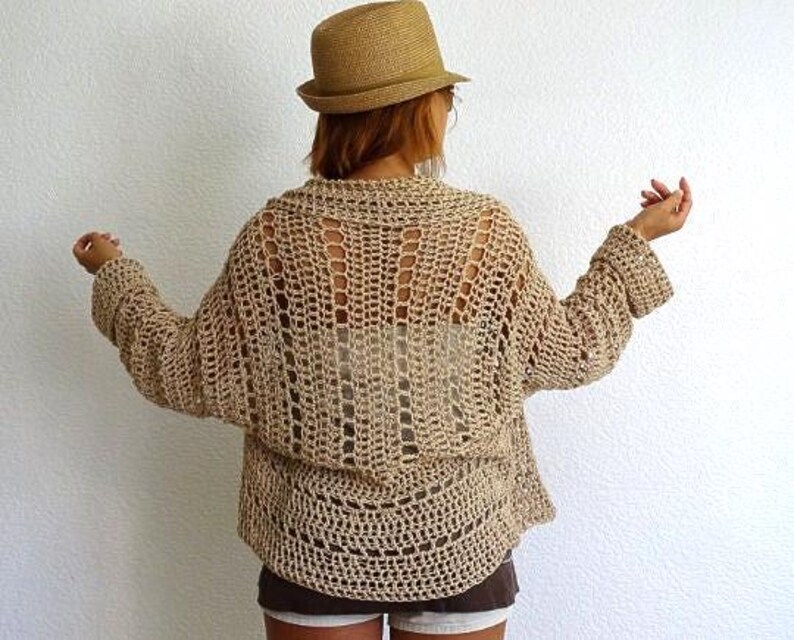 📝 Description:
Boho Crochet Mesh Cardigan – Handmade Lightweight Open Stitch Sweater

Embrace effortless summer style with this hand-crocheted openwork cardigan. Crafted with breathable natural Eco cotton yarn in a neutral sand beige tone, this airy, oversized sweater is perfect as a stylish beach cover-up or a relaxed boho layering piece.