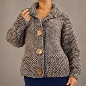 Ash brown bulky hand knit wool cardigan with a relaxed oversized fit, wide collar and three natural coconut buttons.