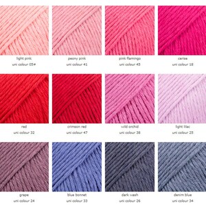 May include: A collection of yarn samples in various shades of pink, red, purple, blue, and gray. The yarn is labeled with the color name and uni color number.