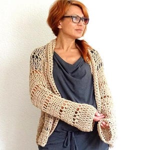 Featuring a wide, open front mesh design and loose sleeves, this lightweight cardigan brings both comfort and style ideal for pairing with tanks, dresses, or swimwear. Whether you're headed to a festival or a sunset walk, this versatile piece completes your warm weather look.
Handmade crocheted boho style bolero cardigan cover up.