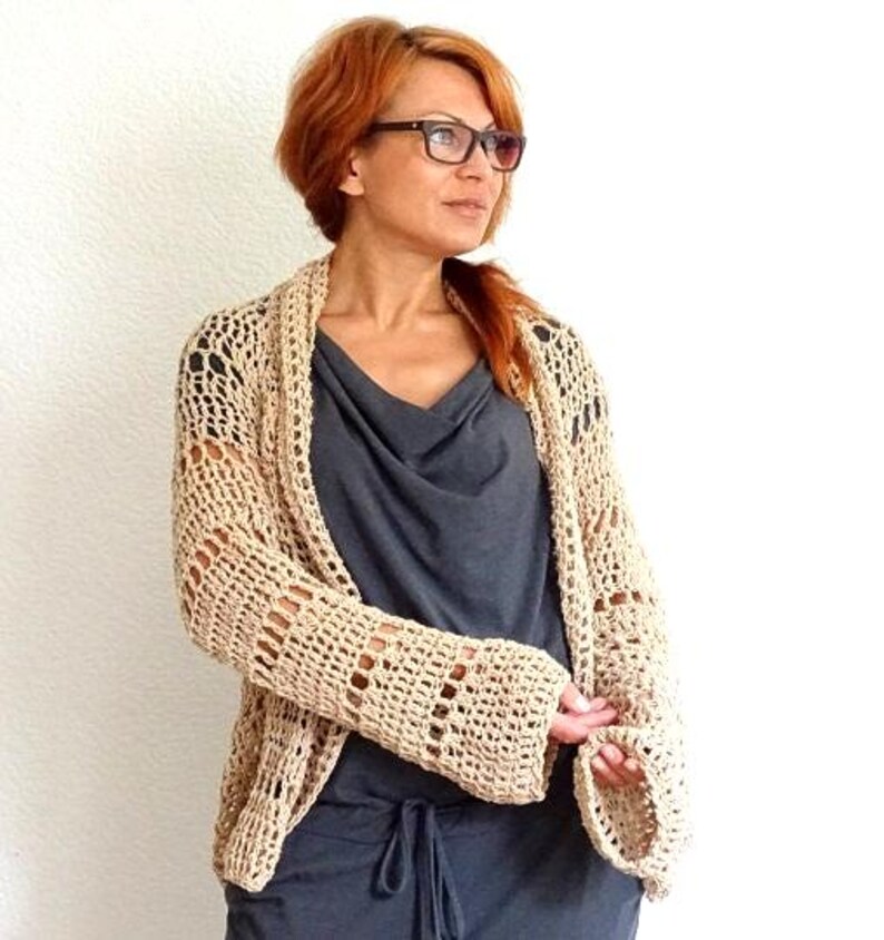 Featuring a wide, open front mesh design and loose sleeves, this lightweight cardigan brings both comfort and style ideal for pairing with tanks, dresses, or swimwear. Whether you're headed to a festival or a sunset walk, this versatile piece completes your warm weather look.
Handmade crocheted boho style bolero cardigan cover up.