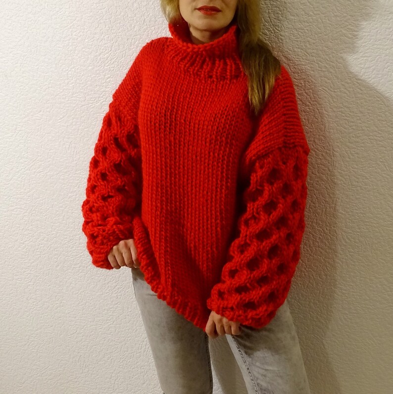 May include: A red knitted sweater with a turtleneck and bubble sleeves.
