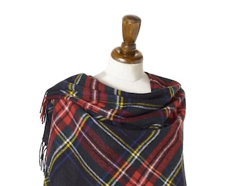 May include: A black, red, and yellow plaid shawl with fringe. The shawl is draped over a mannequin.